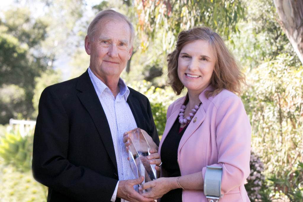 Kjell Rudestam and President Katrina Rogers with award